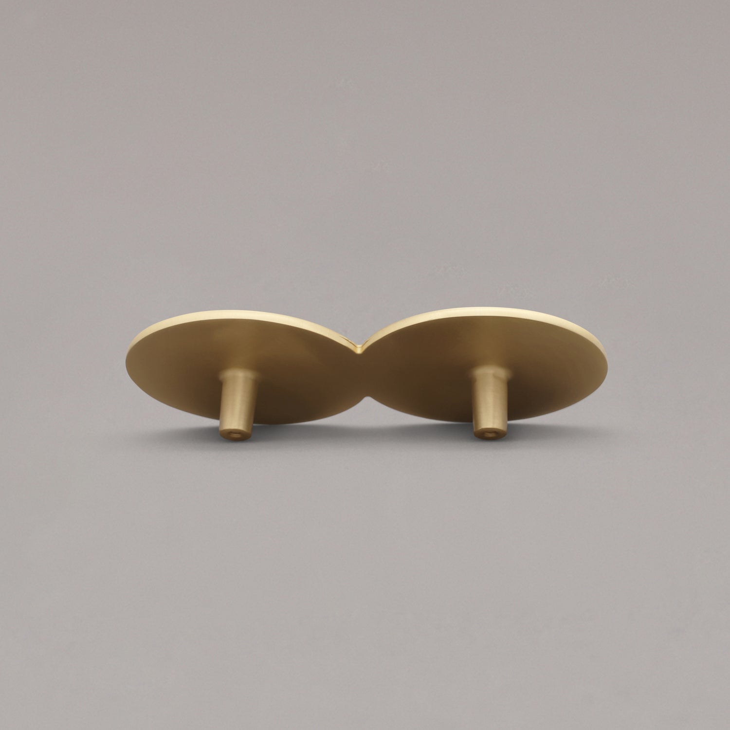 Satin brass cabinet pull on a gray background
