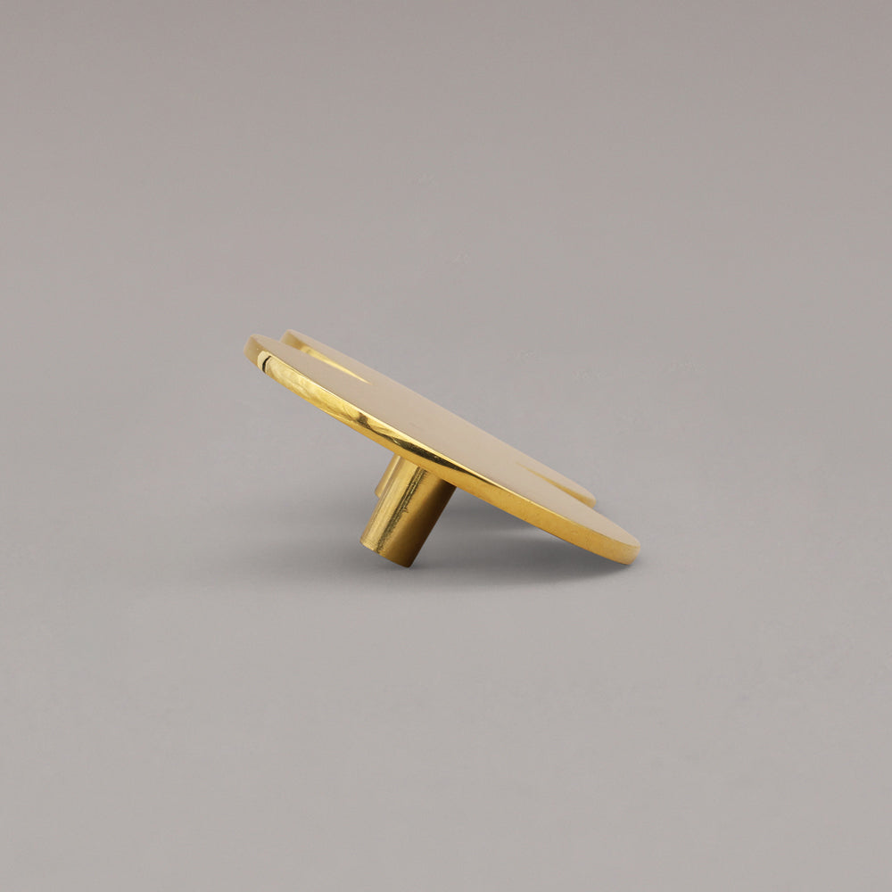 Oversized Unlacquered Polished Brass Cabinet Pull on a gray background