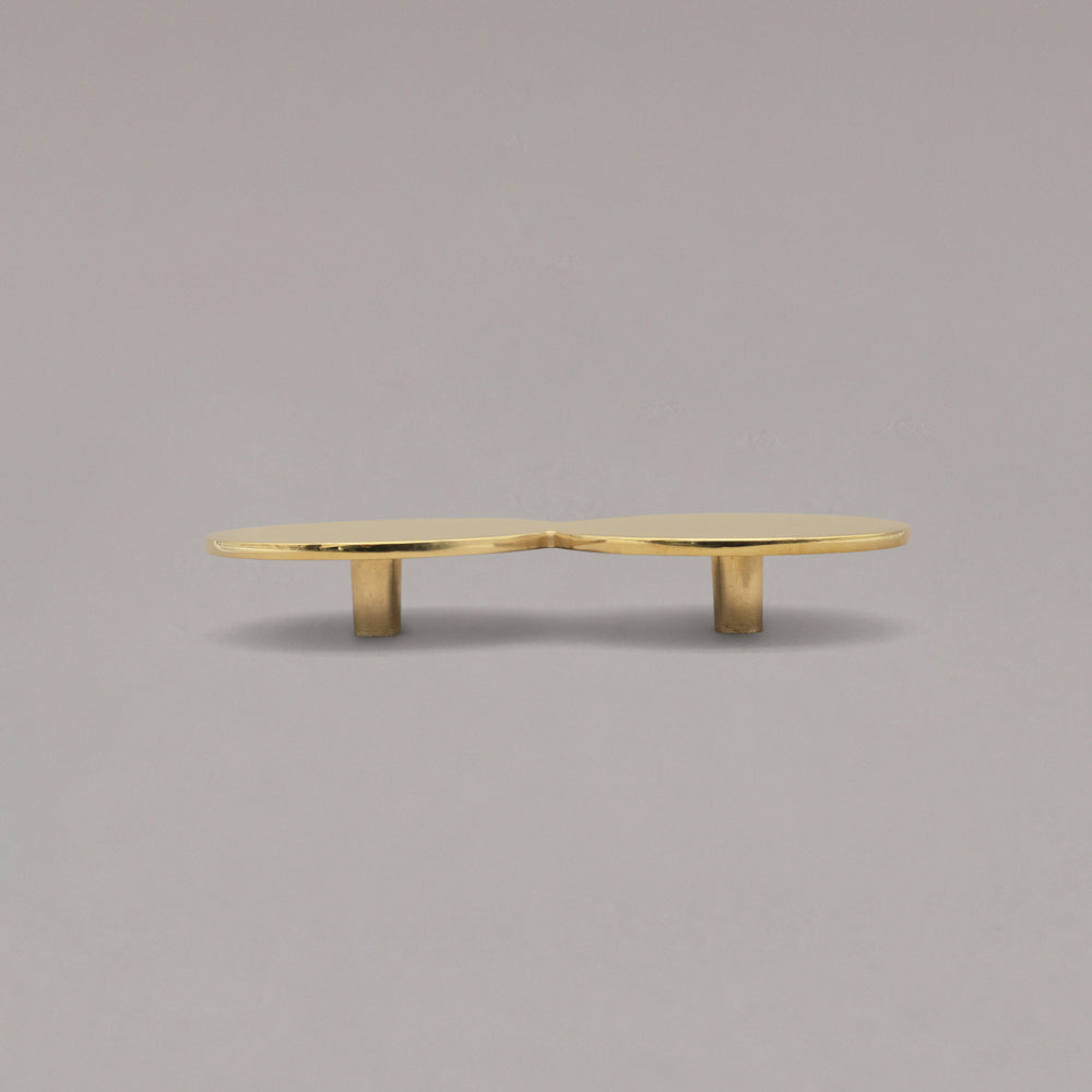 Oversized Unlacquered Polished Brass Cabinet Pull on a gray background