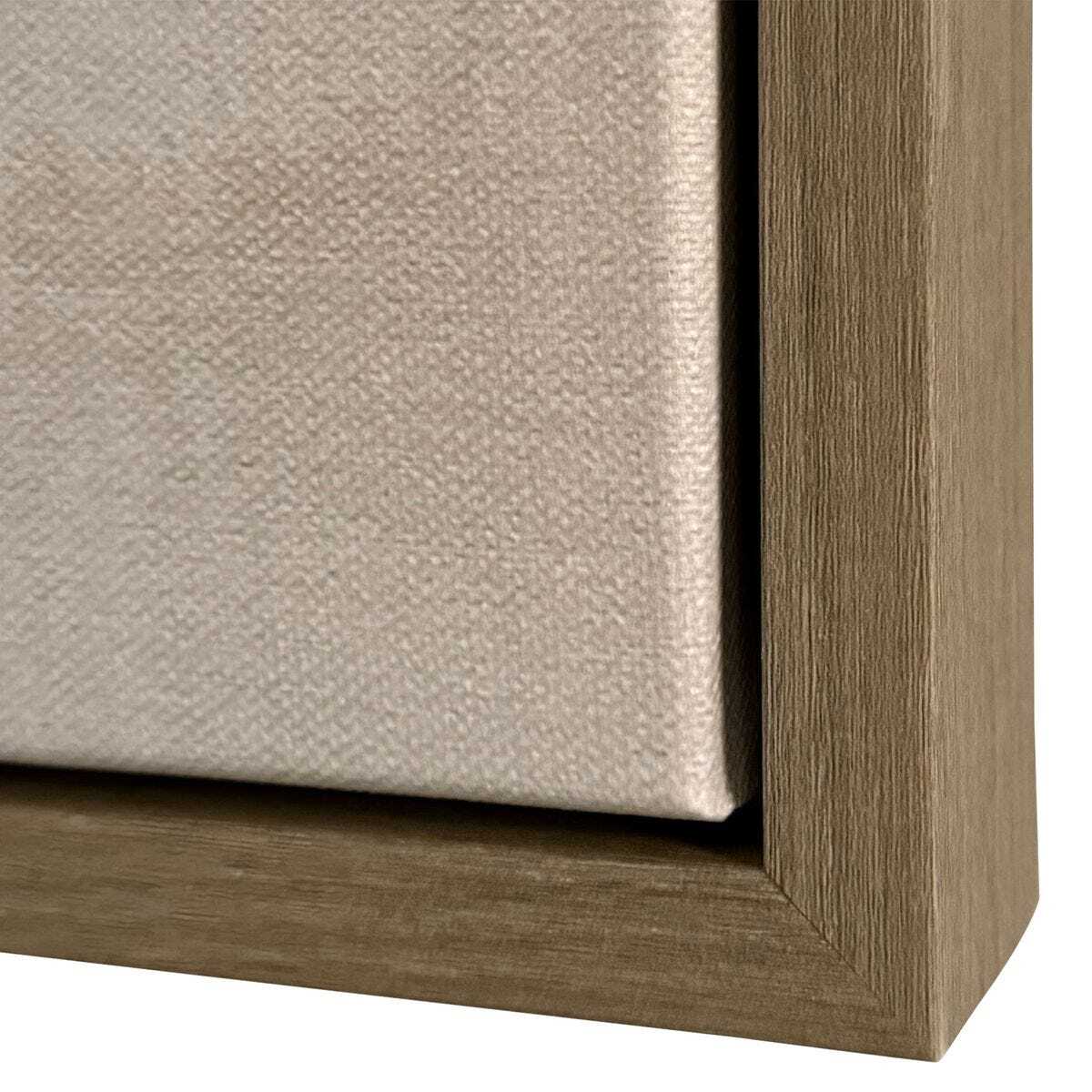 Close-up of a wooden picture frame corner with beige textured canvas.