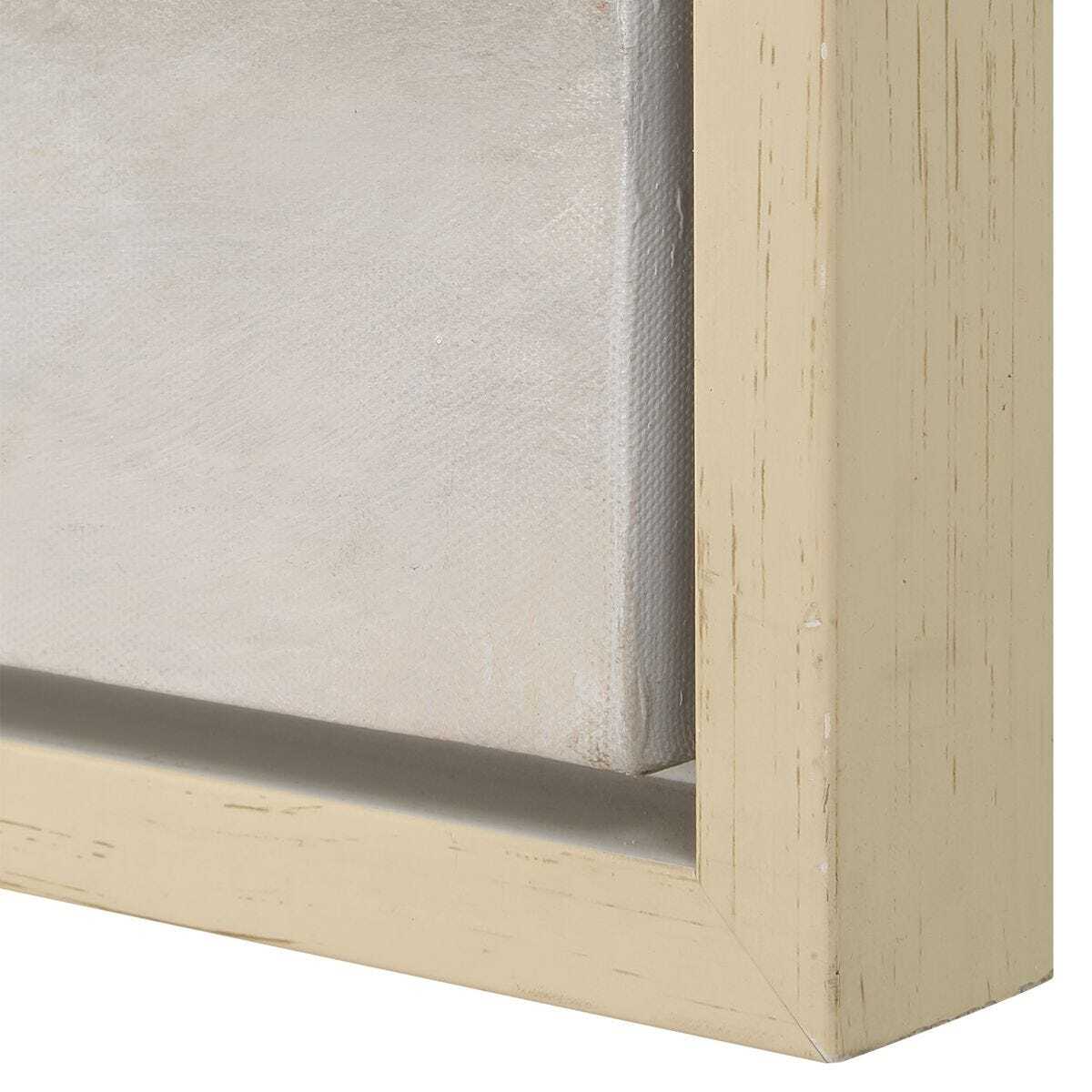 Close-up of a wooden picture frame corner with a textured beige finish.