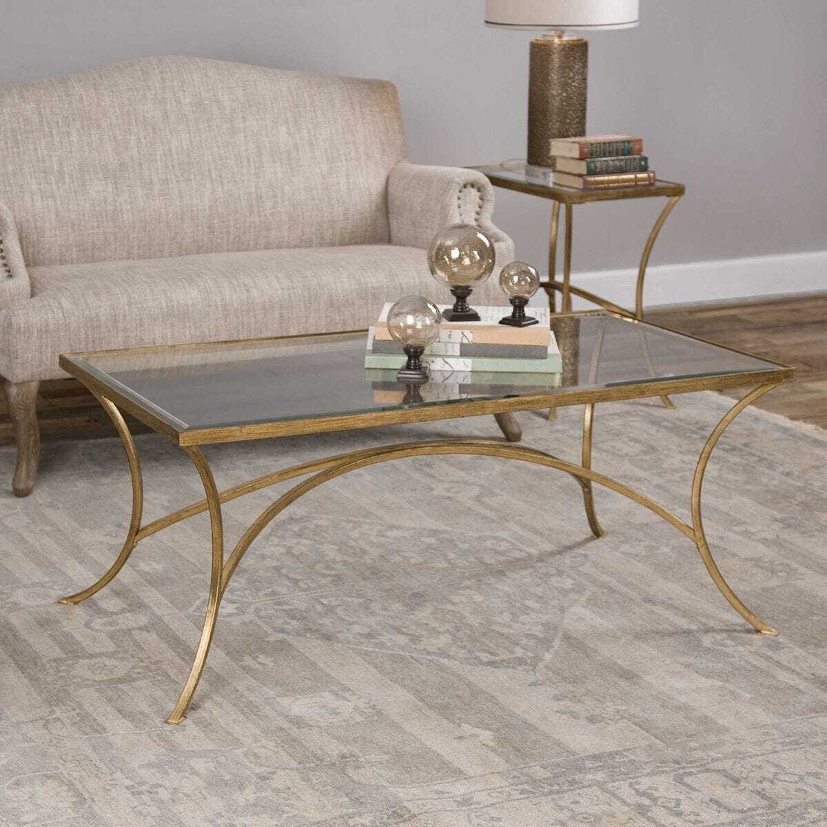 Gold coffee table with glass top in a living room setting
