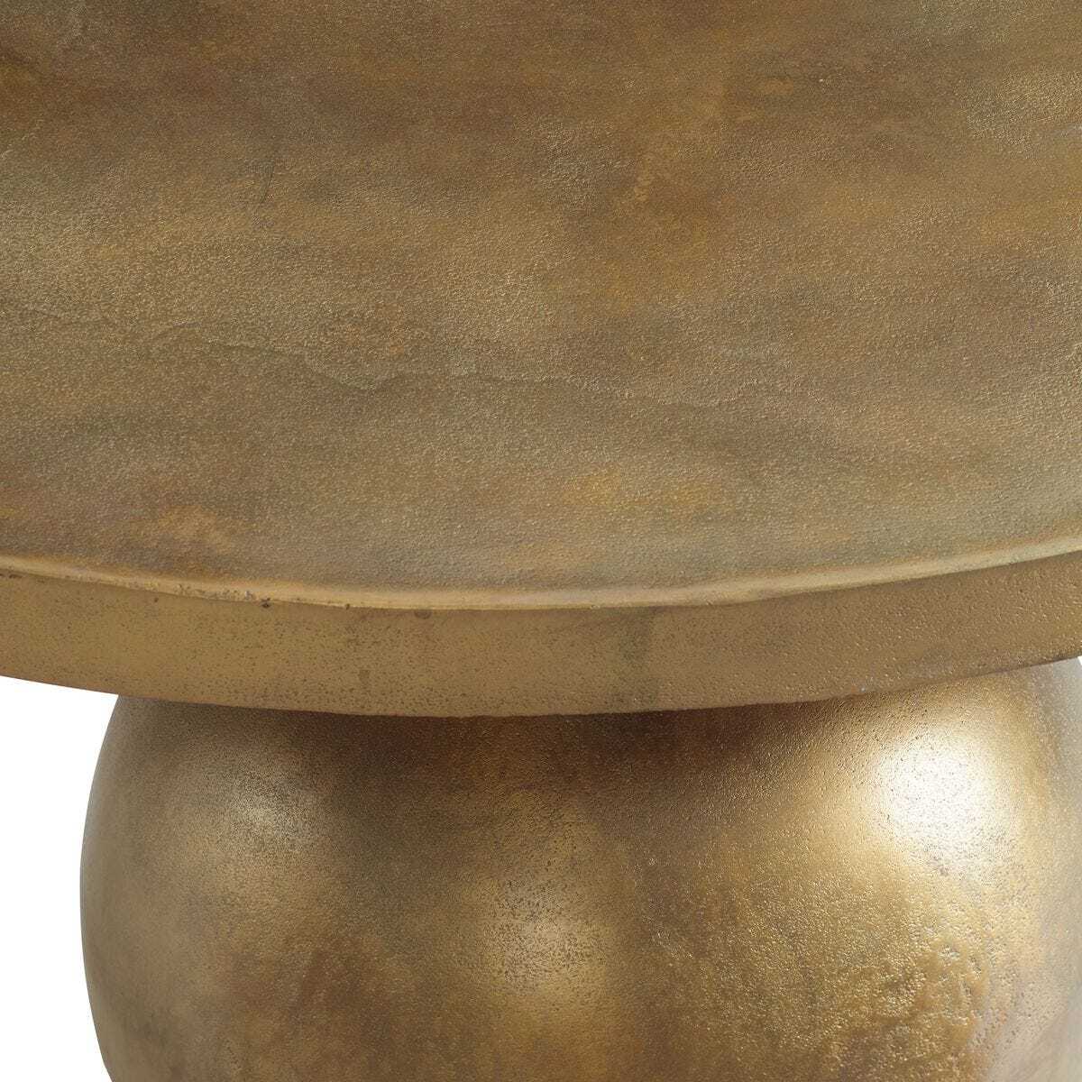 Bronze-colored round table with a textured surface on a white background