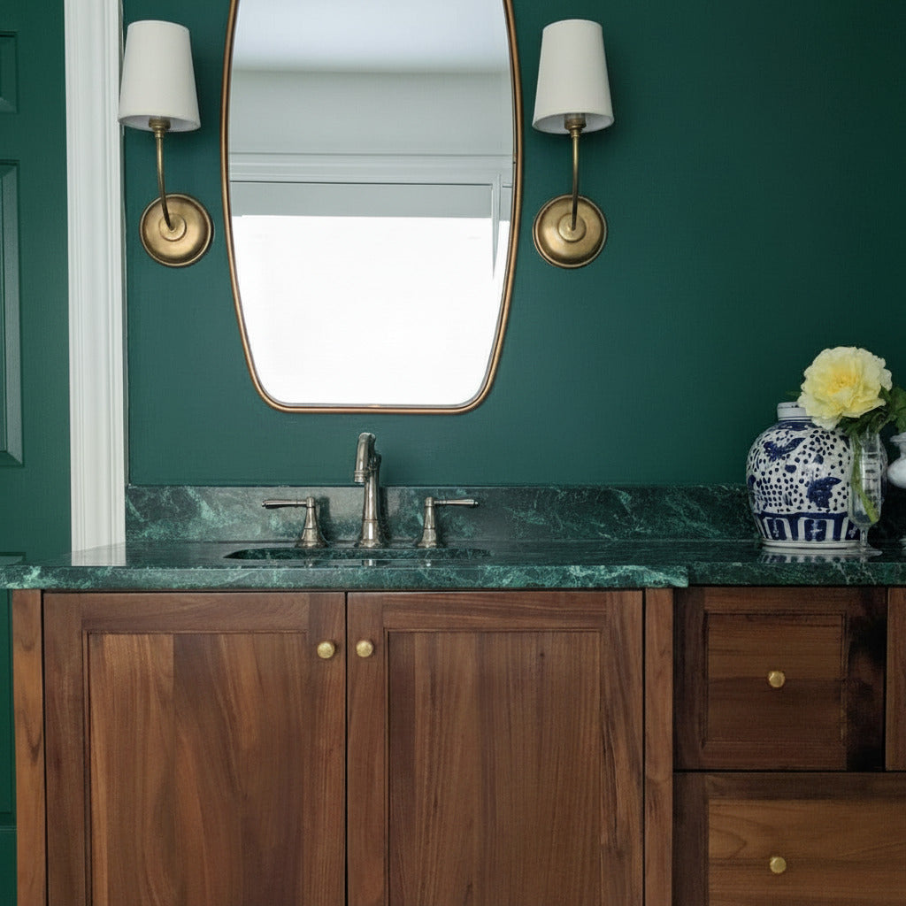 Antique gold bathroom vanity with wooden cabinets, marble countertop, and decorative elements.