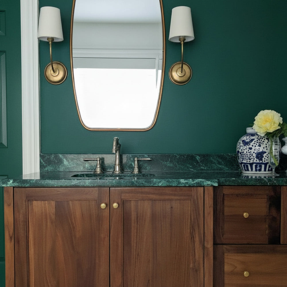 Antique gold bathroom vanity with wooden cabinets, marble countertop, and decorative elements.
