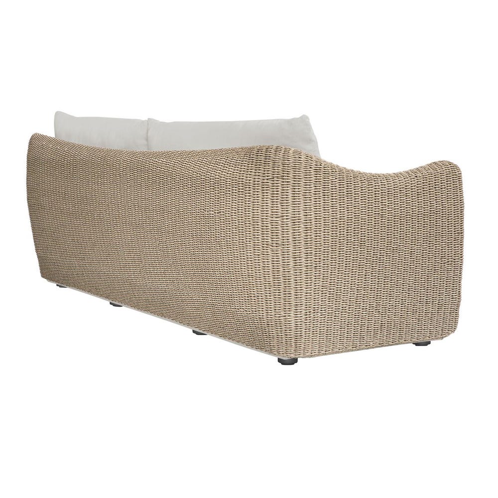 Wicker outdoor furniture piece with white cushion on a white background