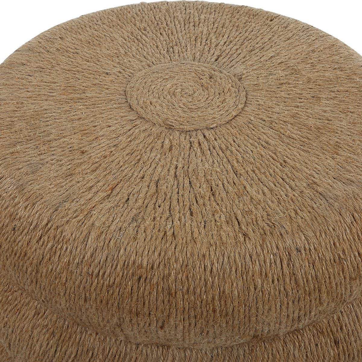 Round woven ottoman with a textured surface on a white background