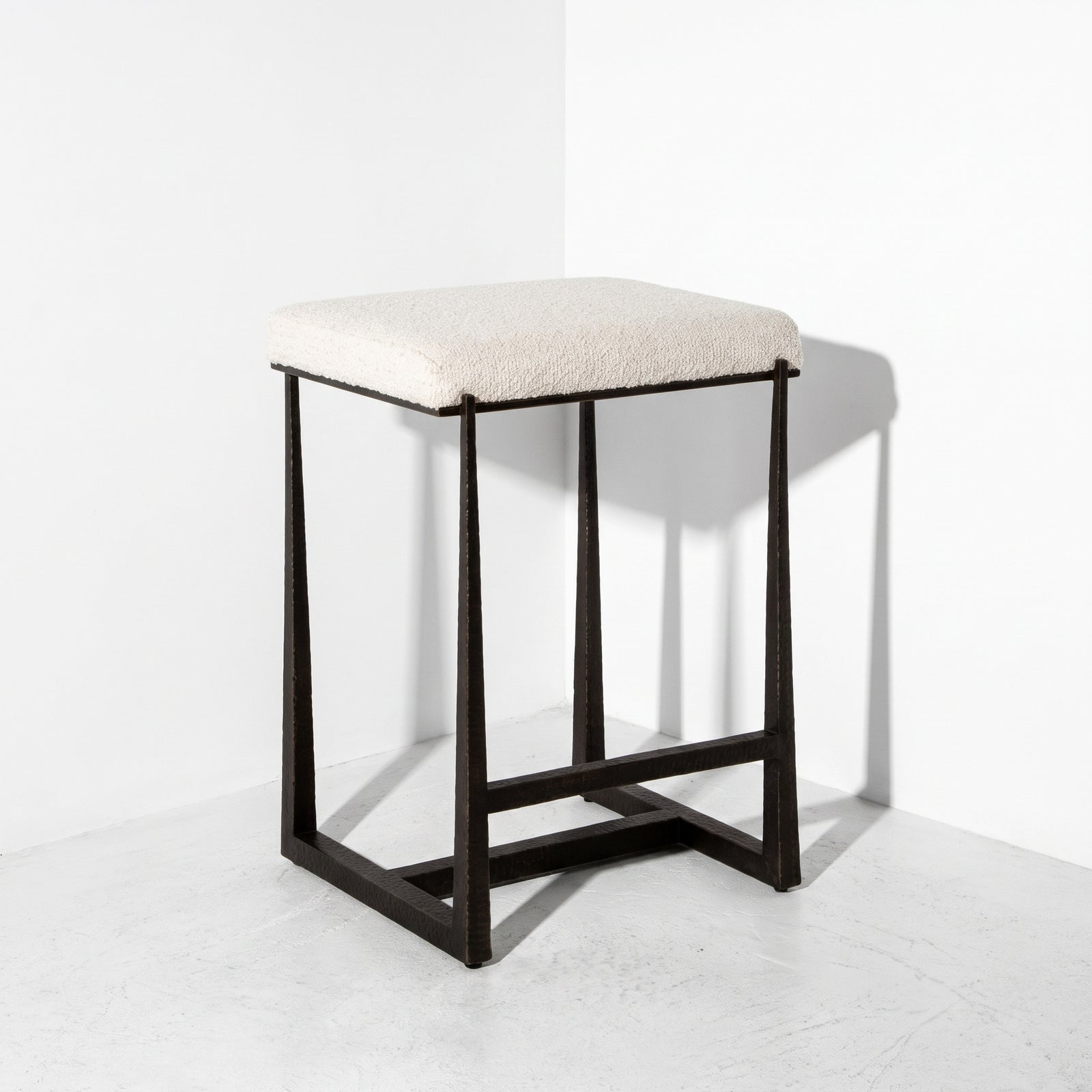 White counter stool fabric in front of a corner.