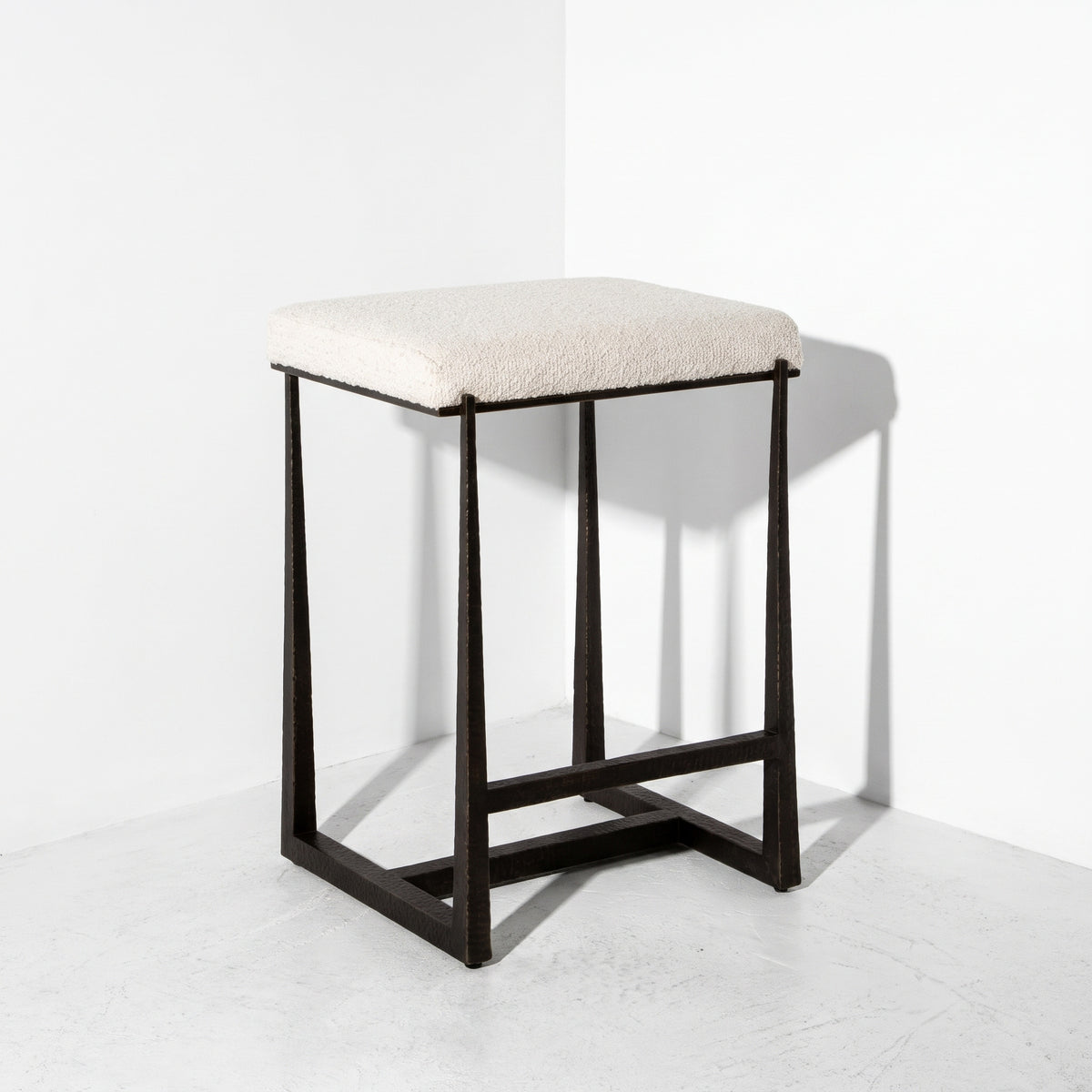 White counter stool fabric in front of a corner.