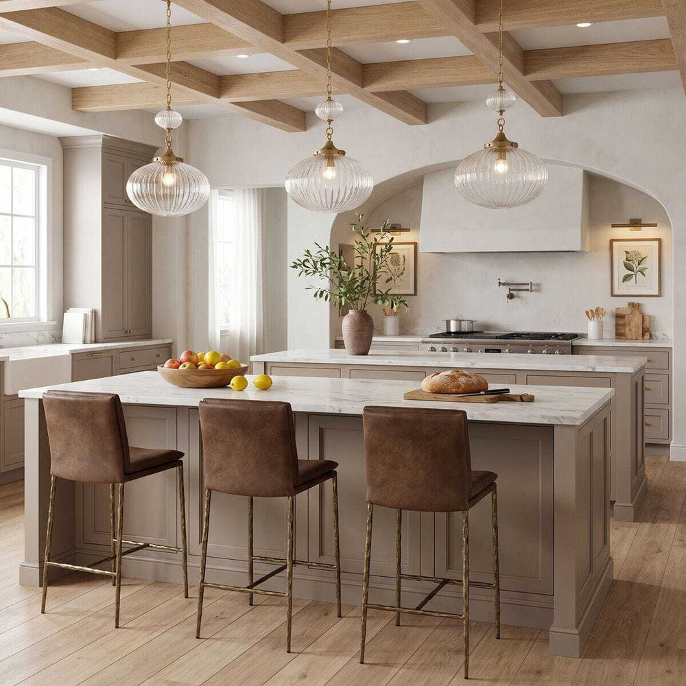 Leather counter stool with bronze sculpted legs in modern kitchen.