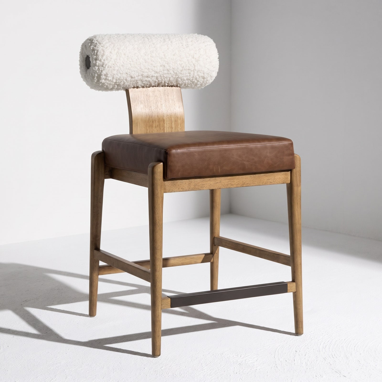 Wood and shear counter stool with leather cushion.