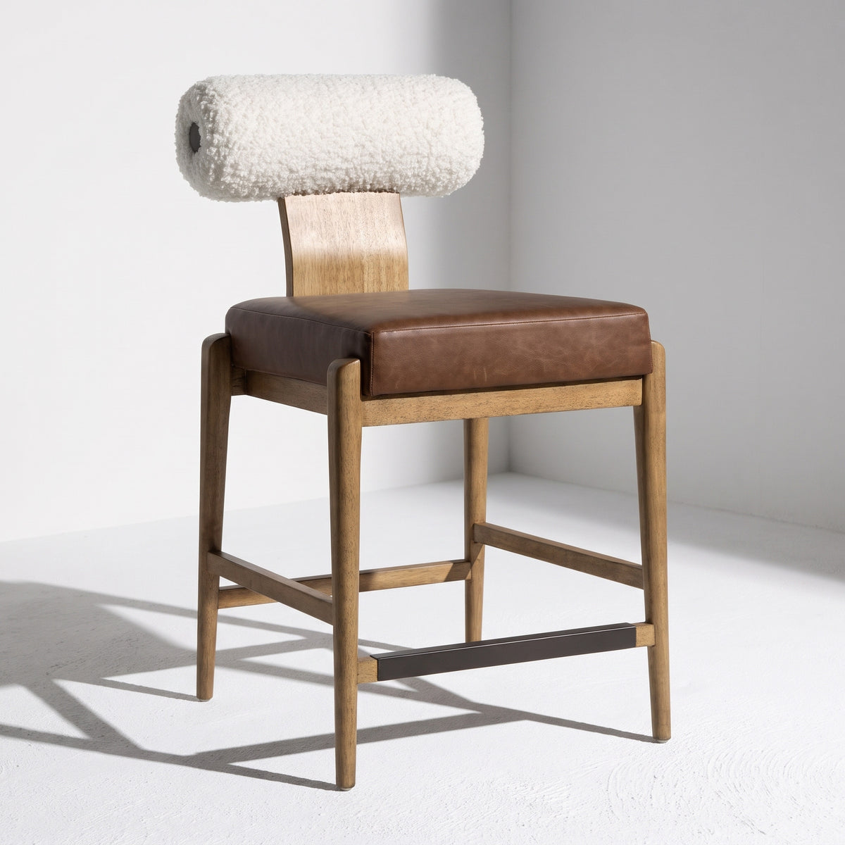 Wood and shear counter stool with leather cushion.