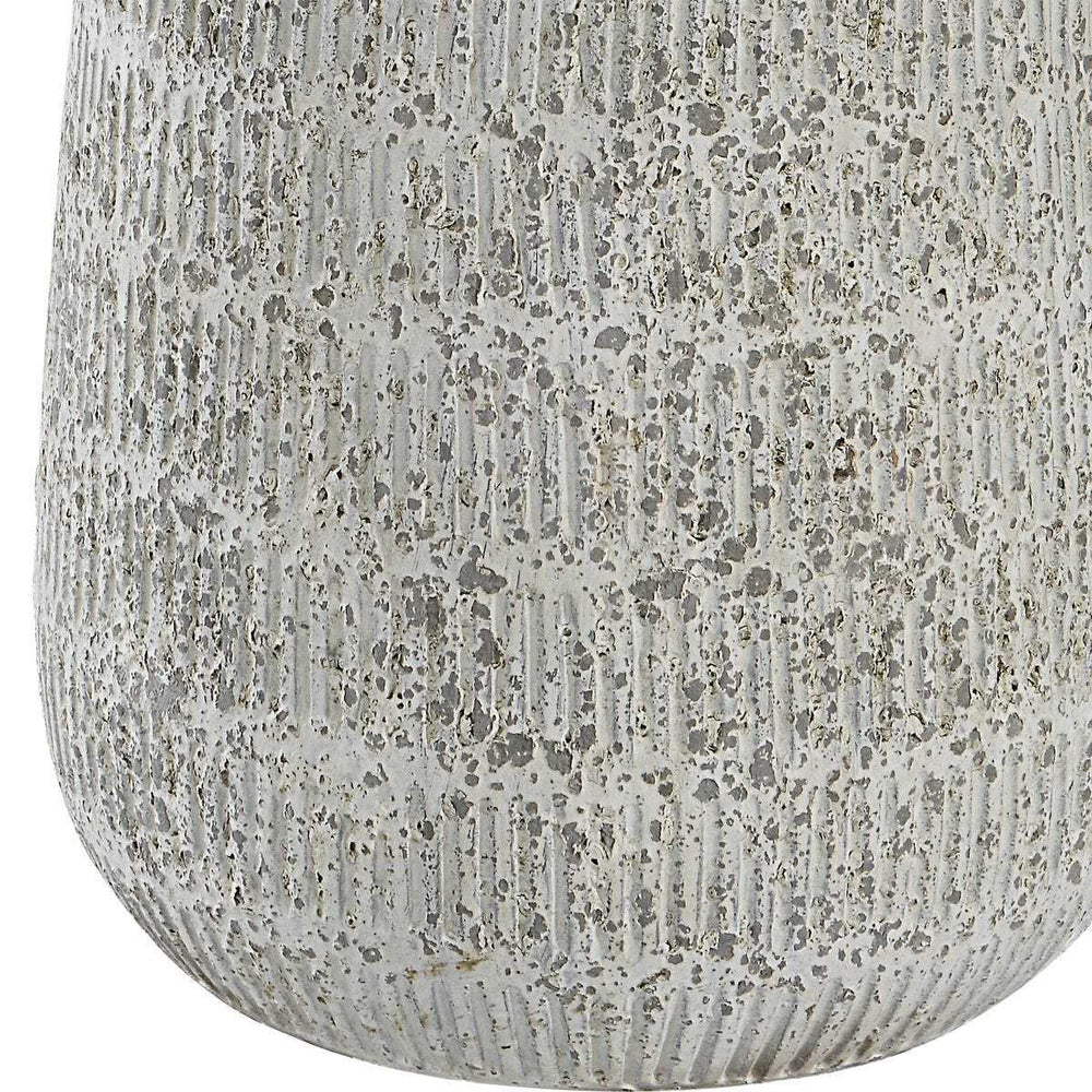 Close-up of a textured gray ceramic vase on a white background