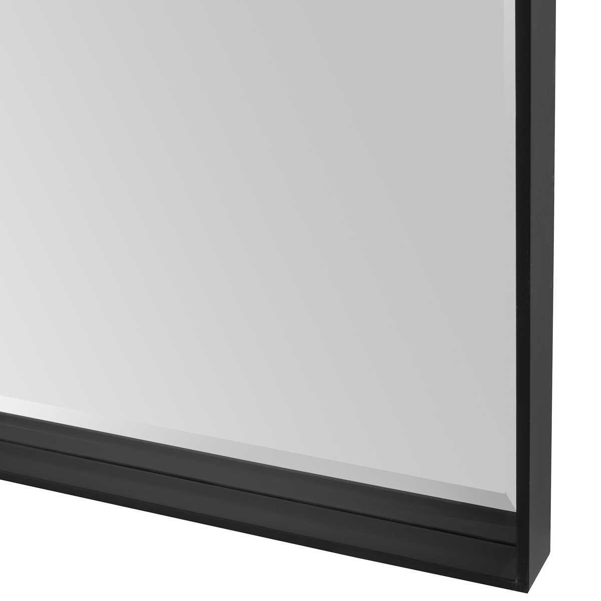 Close-up of a black-framed mirror on a white background