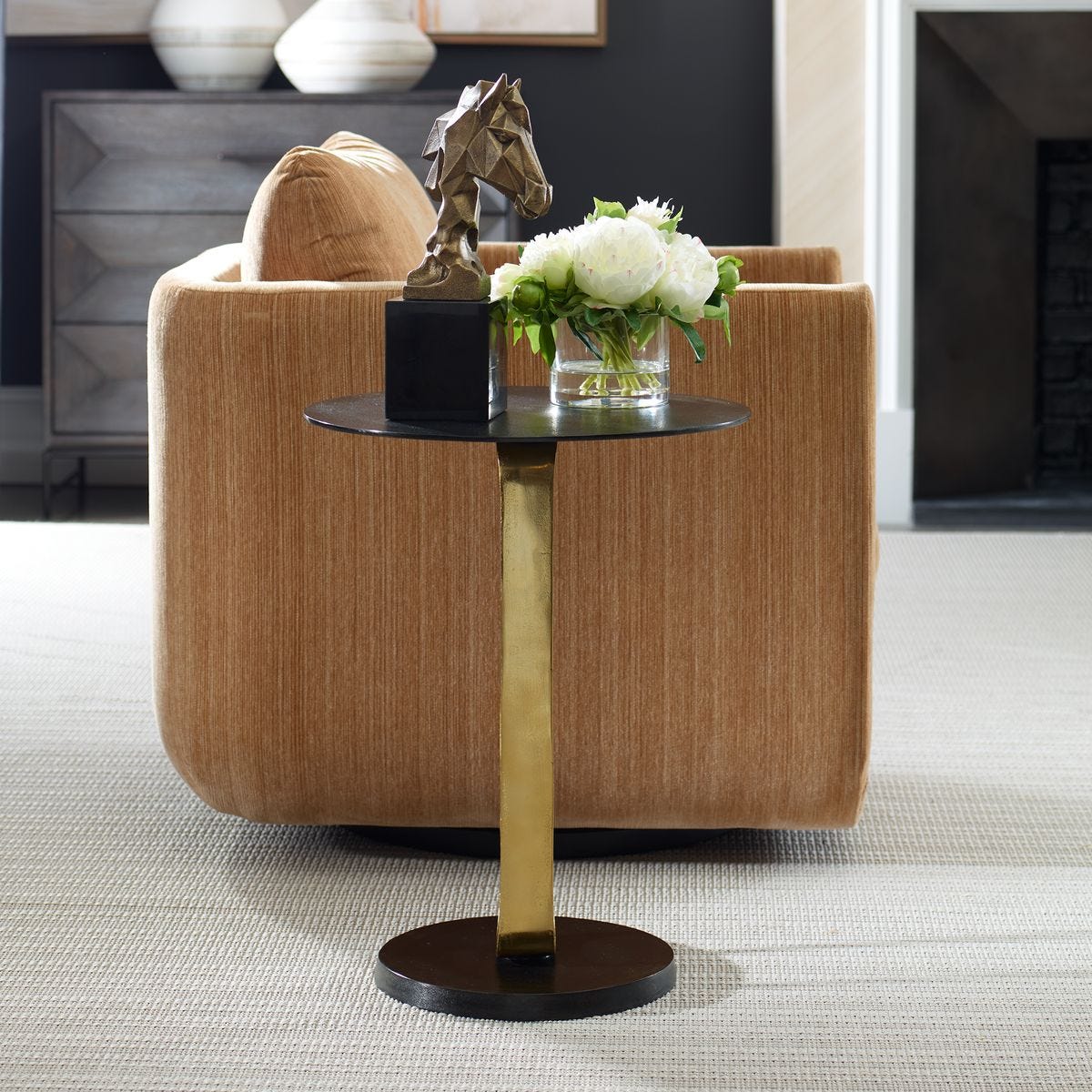 Small round table with decorative items in a living room setting