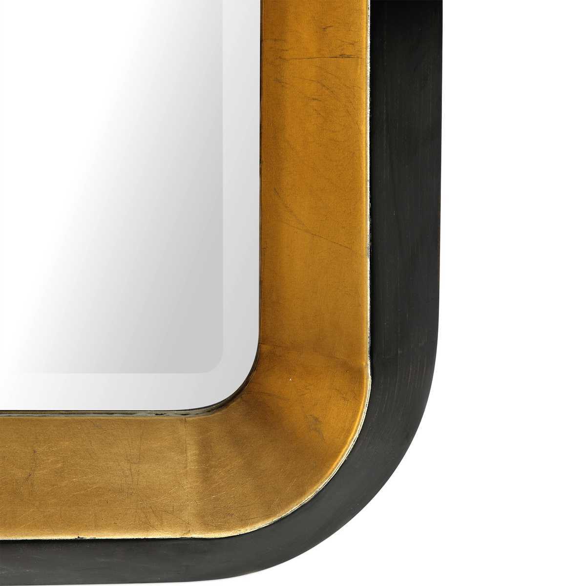 Close-up of a curved surface with gold and black finish on a white background
