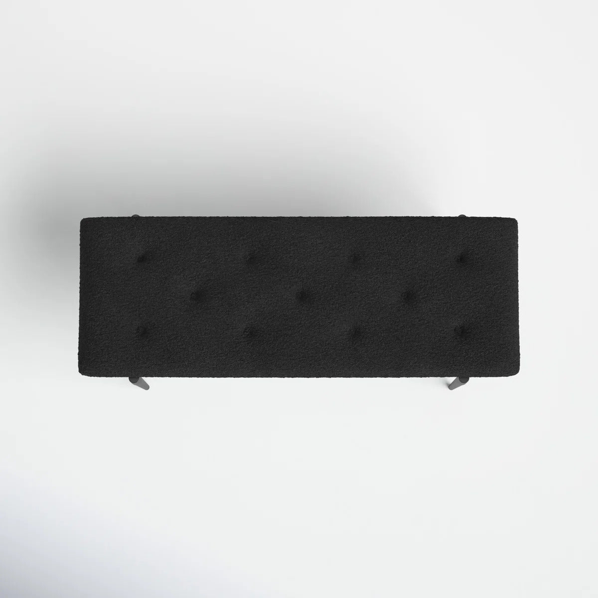 Black upholstered bench on a white background