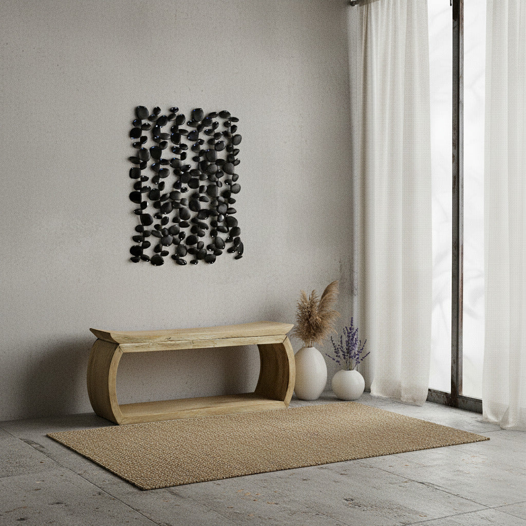 Modern interior with a wooden bench, decorative wall art, and black wall art.