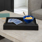 Black coffee table tray on white surface with cereal and cards.