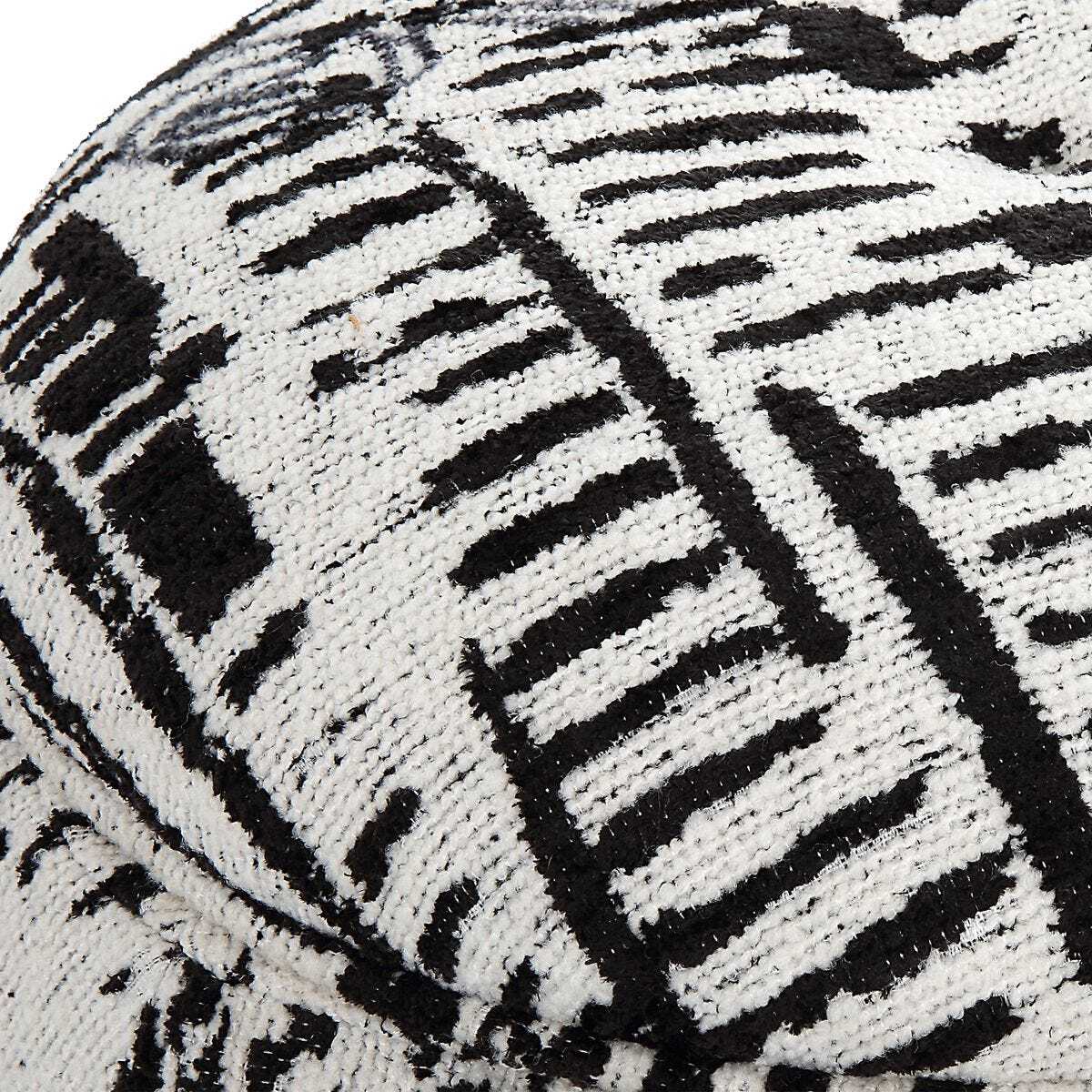 Close-up of a textured black and white cushion with geometric pattern