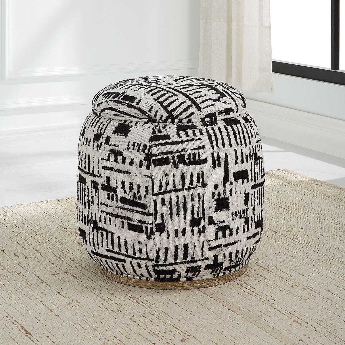 Patterned ottoman on a wooden floor with a light-colored wall in the background