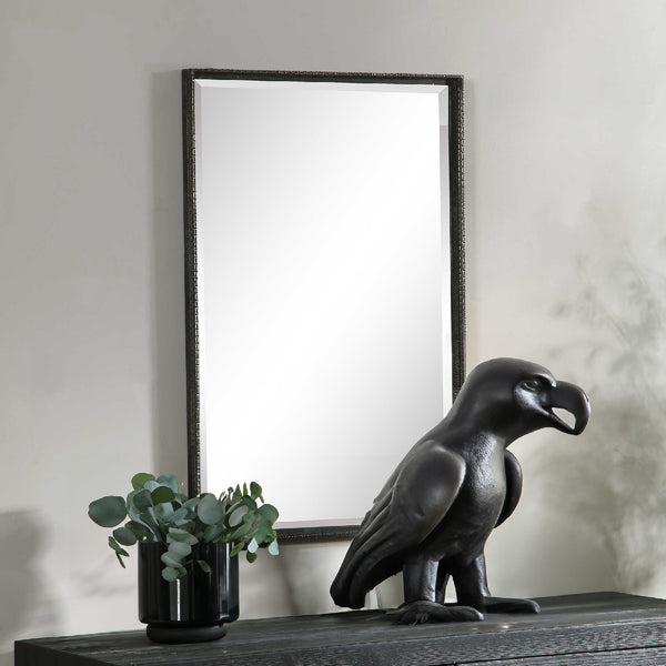 Black console with rectangular mirror and black statue decor.