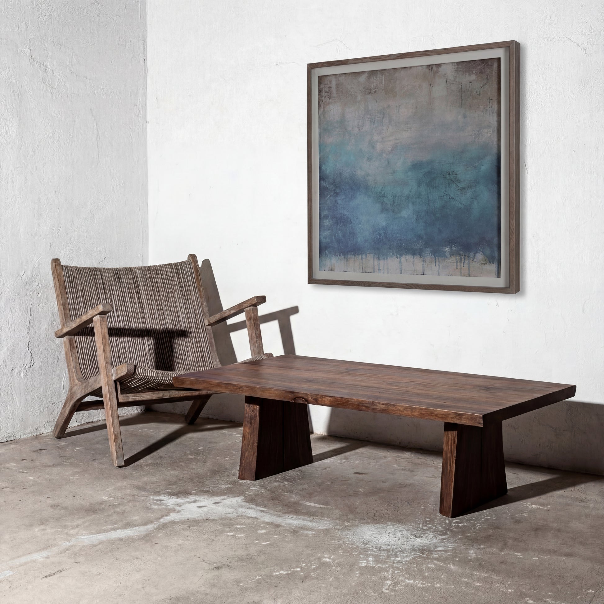 Wooden chair and table with abstract blue painting on a white wall
