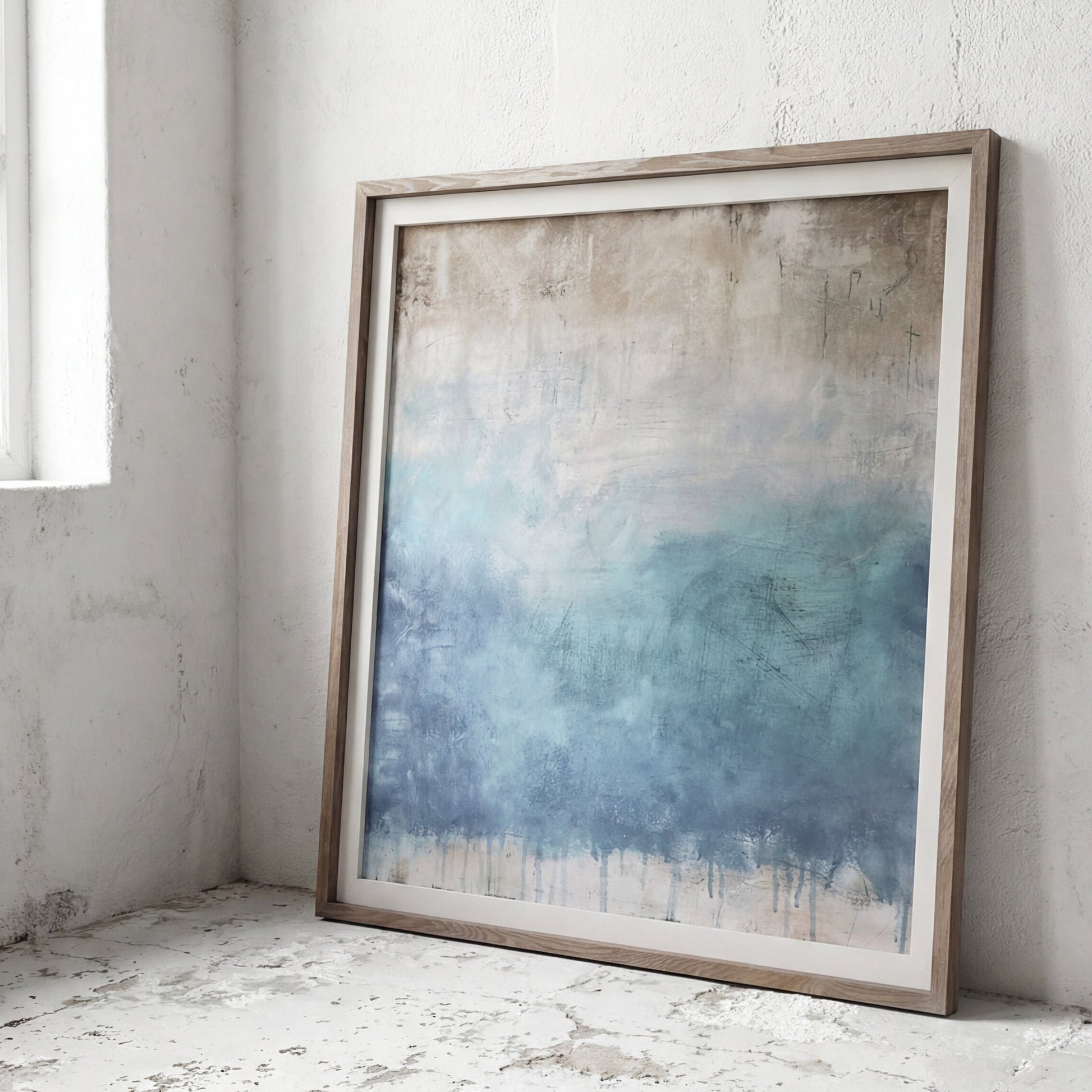 Framed abstract art piece on a textured white wall
