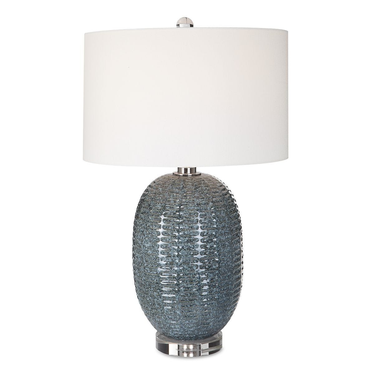 Table lamp with textured gray base and white shade on a white background