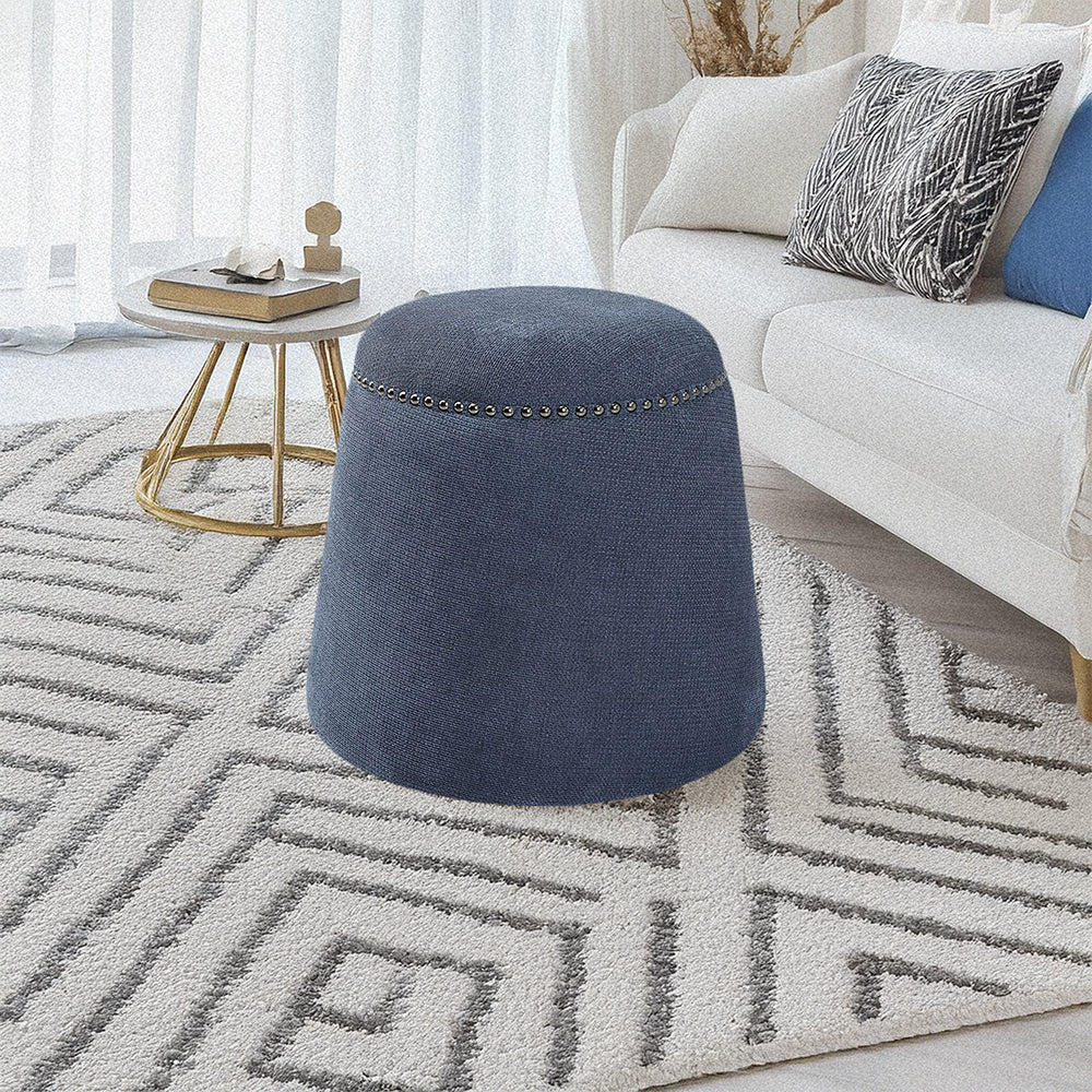 Blue ottoman in coastal white living room.