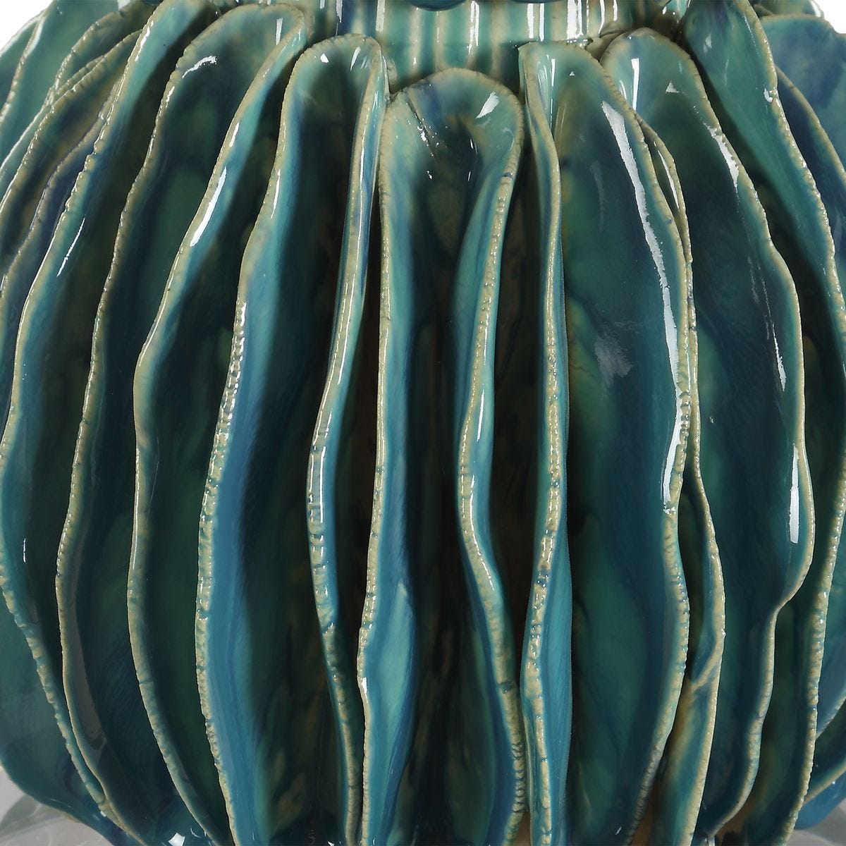 Close-up of a textured teal ceramic vase