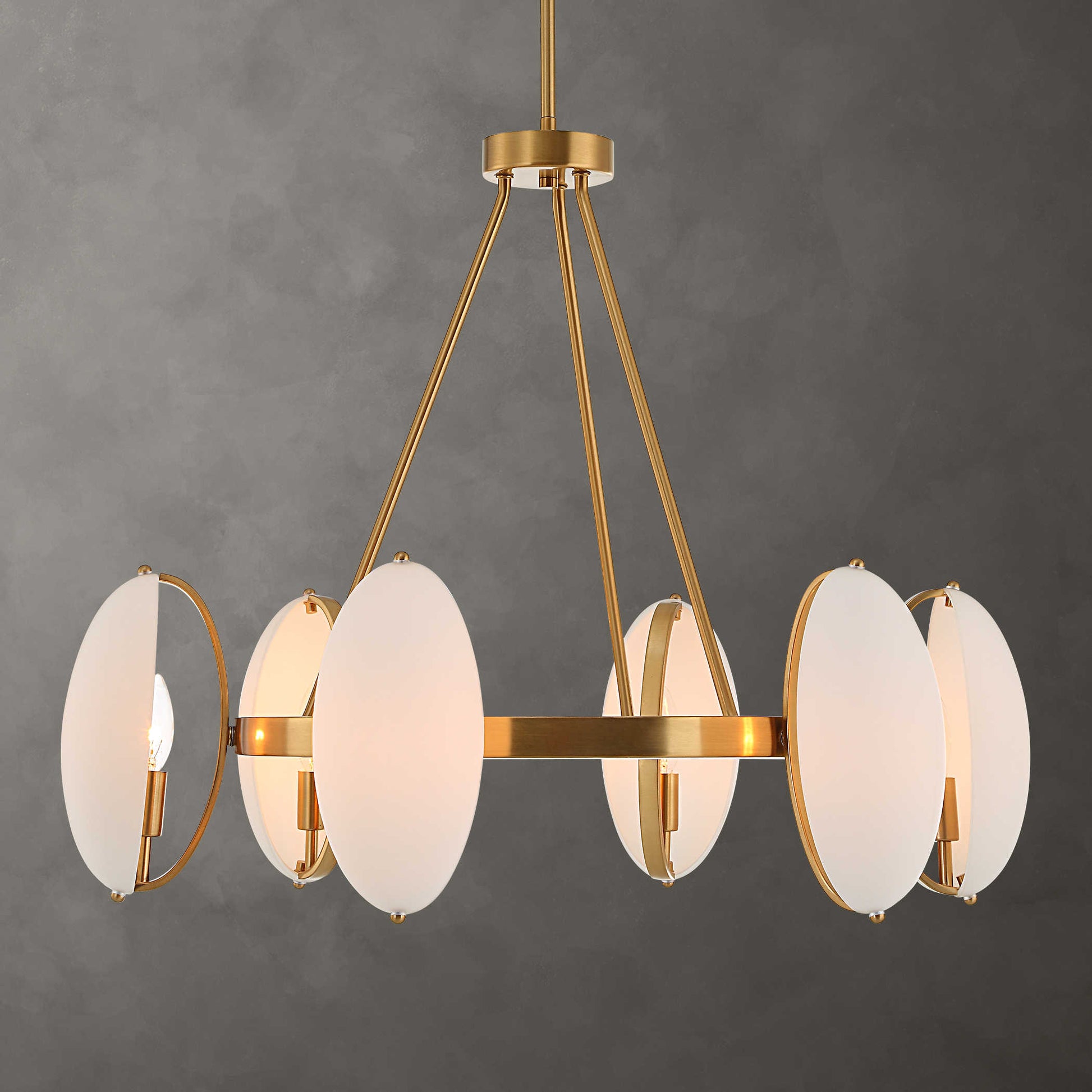 A contemporary chandelier with warm brass finish and modern matte opal dome oval glass.