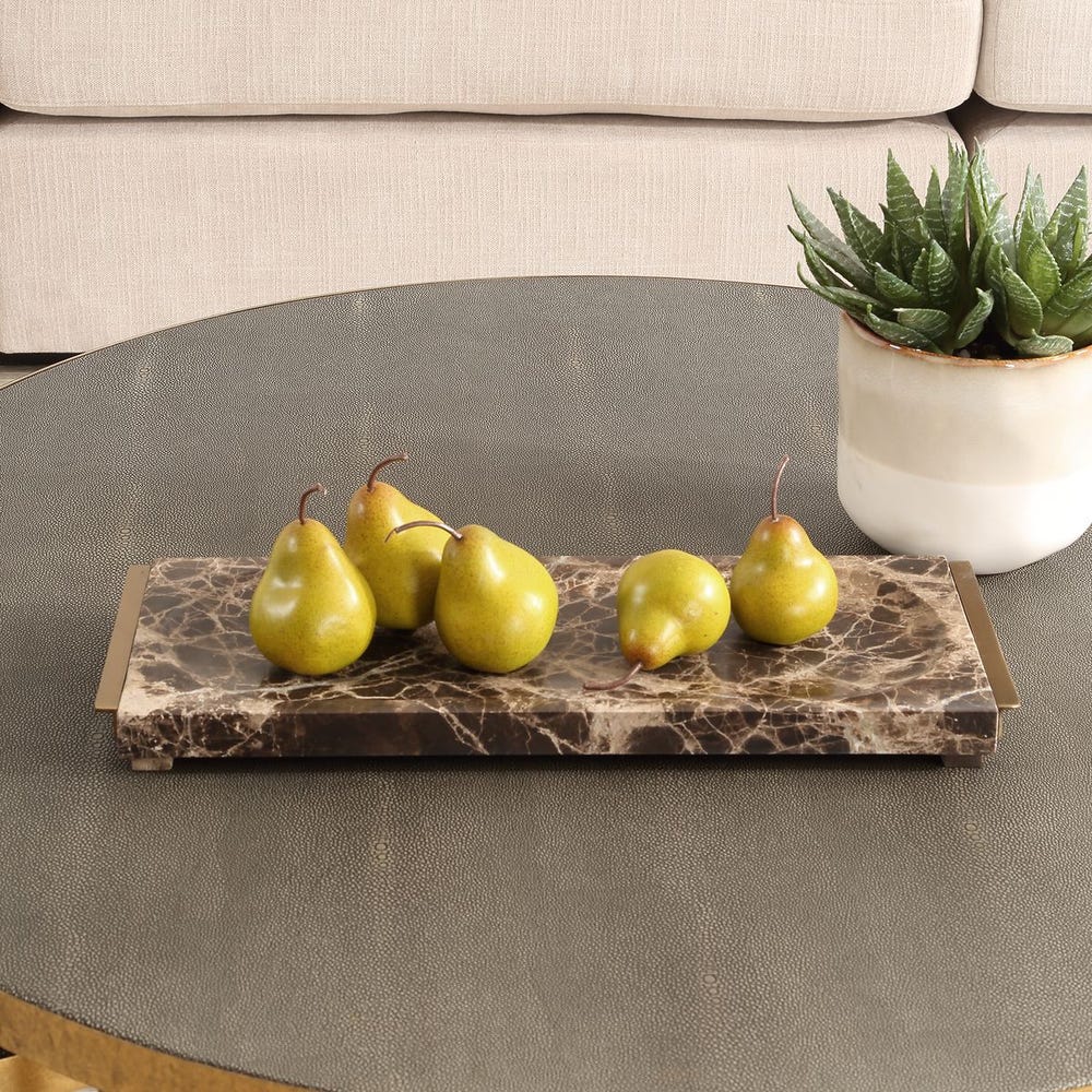 Marble tray with pears on a coffee table next to a plant