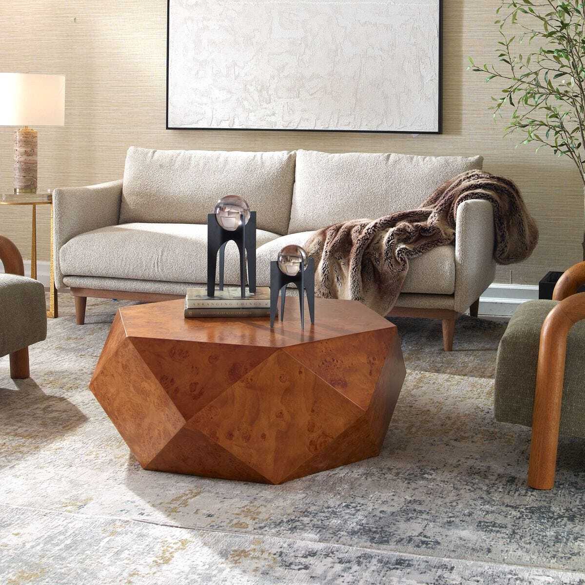 Modern living room with a geometric wooden coffee table and a beige sofa.