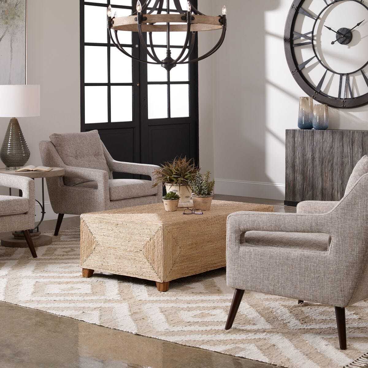 Living room with gray armchairs, a wooden coffee table, and decorative items.