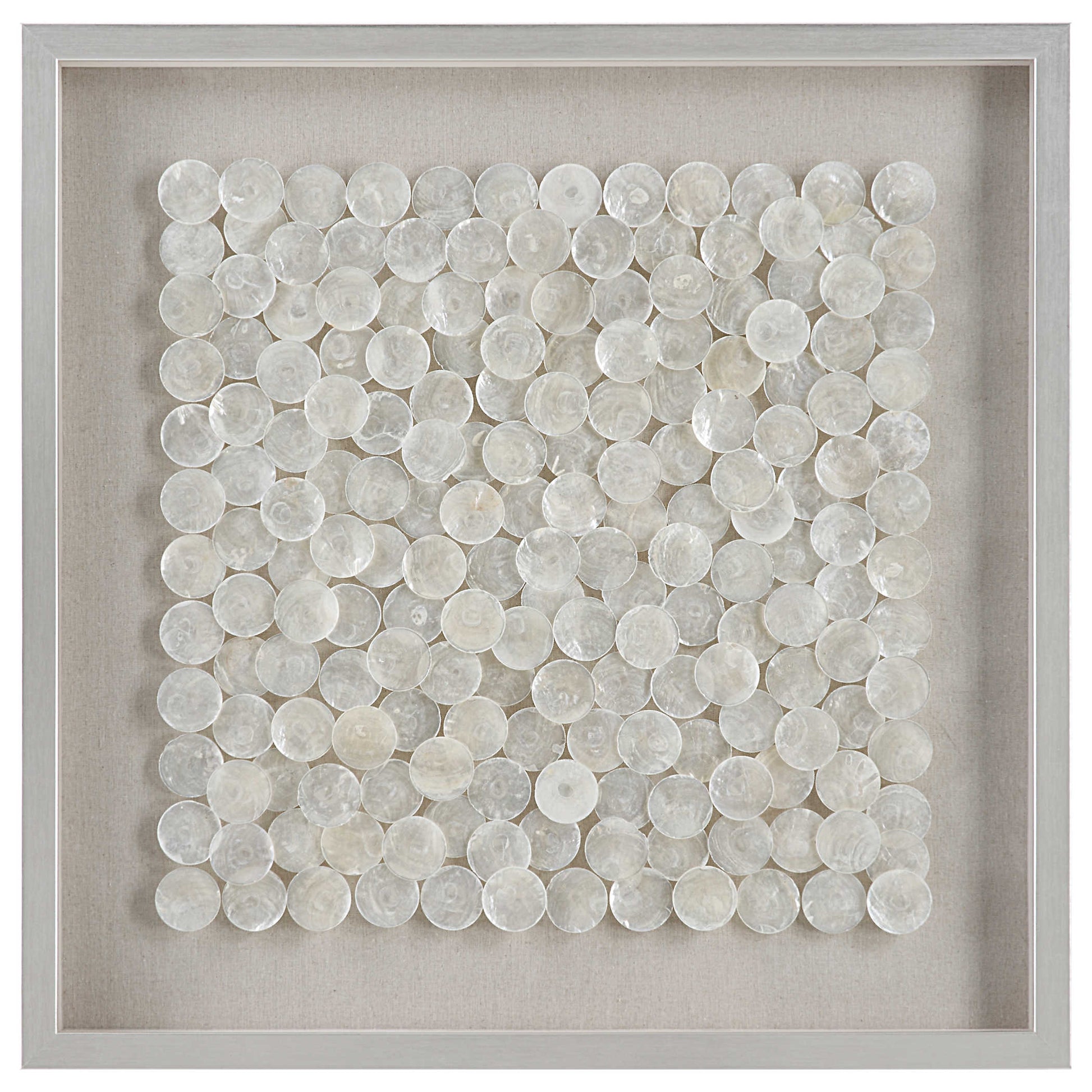 A shadow box style wall piece featuring natural layered capiz shells on a flax-toned linen backing, framed in pine wood with a brushed silver finish.