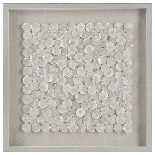 A shadow box style wall piece featuring natural layered capiz shells on a flax-toned linen backing, framed in pine wood with a brushed silver finish.