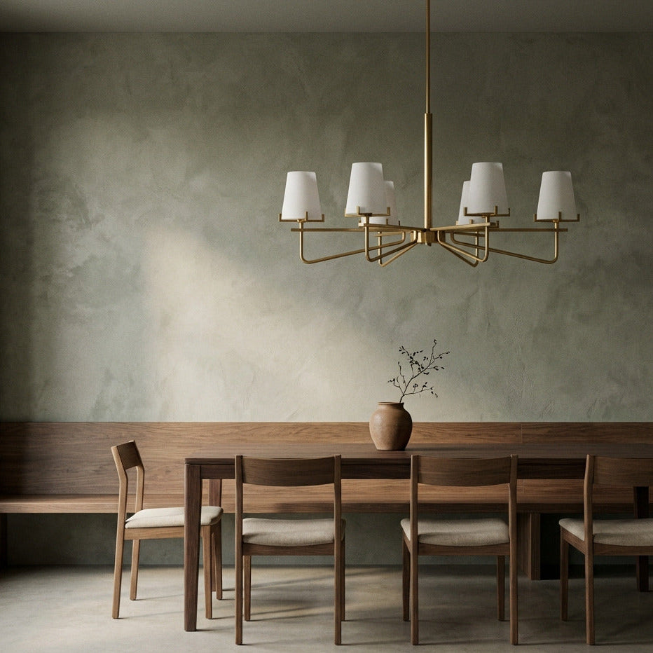 Dining room with wooden table and chairs, gold chandelier, and textured wall.