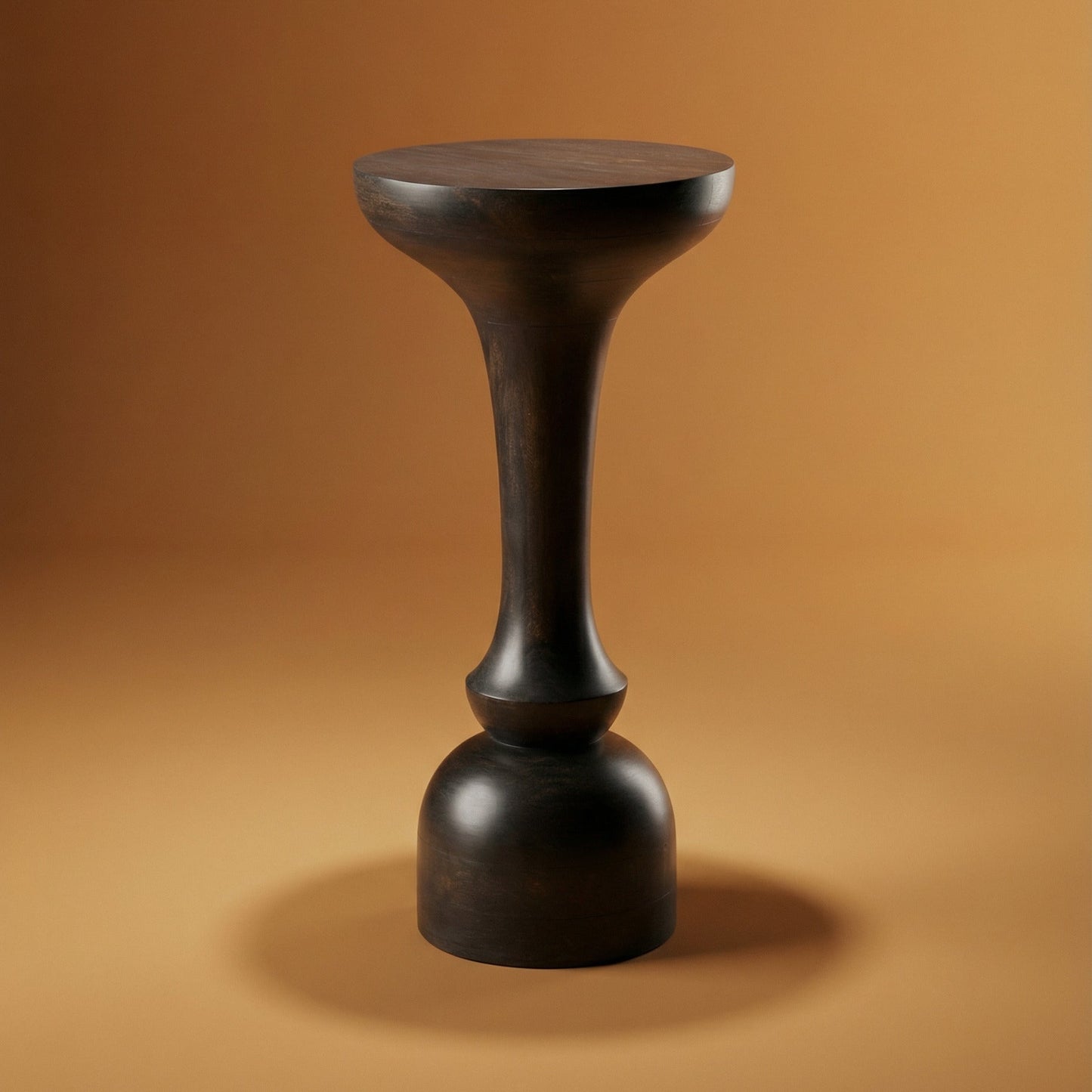 Black cylindrical stool on a brown background