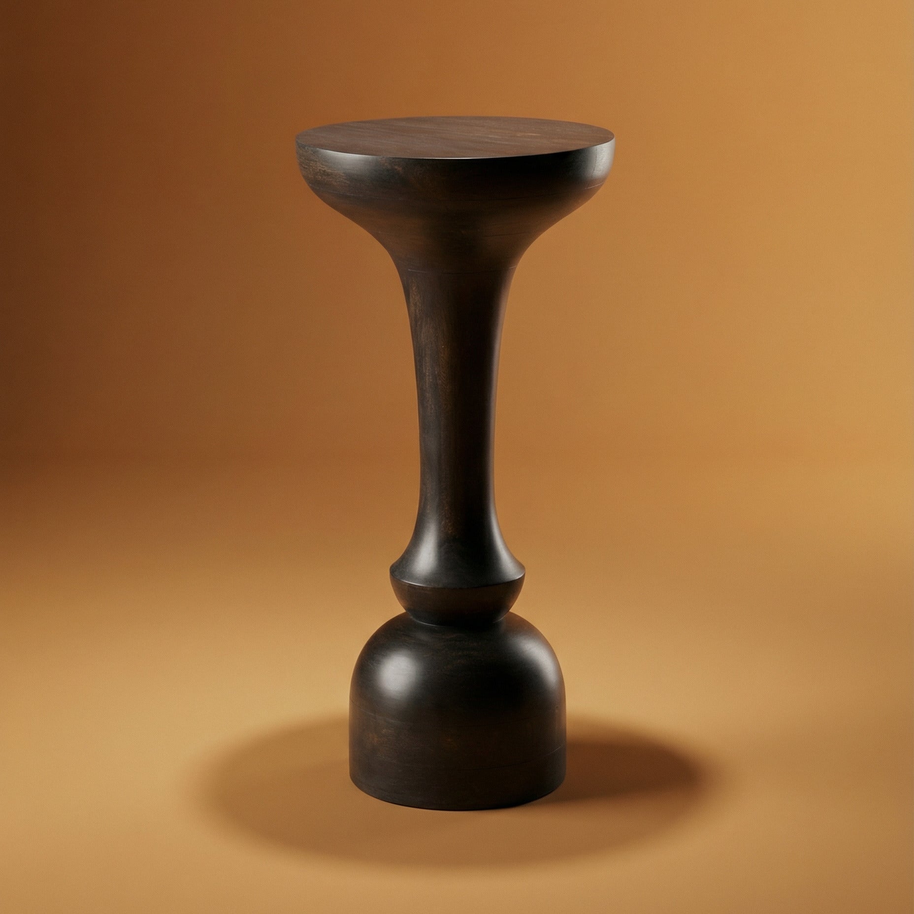 Black cylindrical stool on a brown background