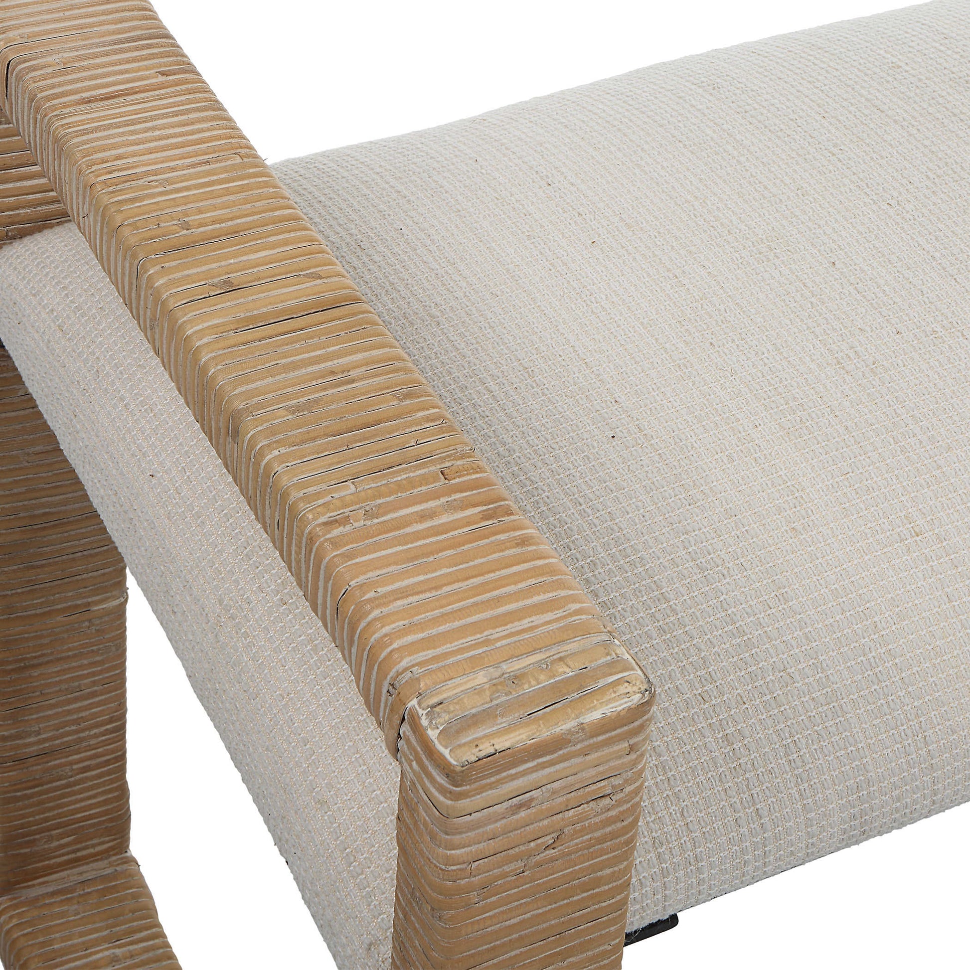 Close up of rattan arm and upholstered cushion.