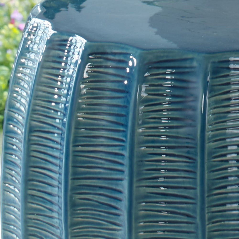 Wavy edges of the teal ceramic garden stool