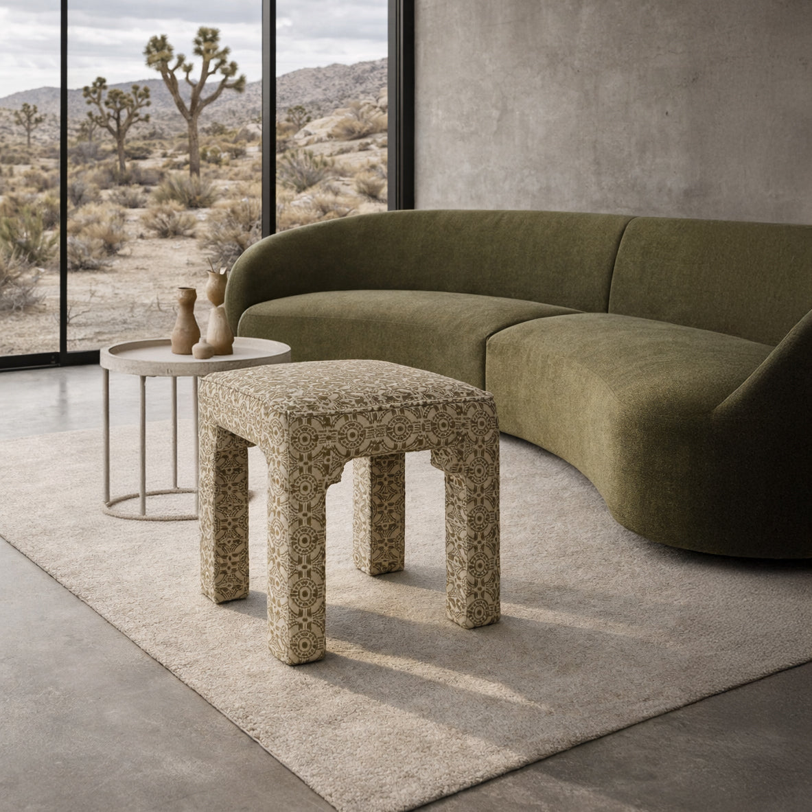 Olive green bench for closet in front of green sofa in a desert home.