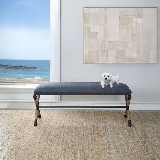 Blue Upholstered nench with Metal Legs and Rope Accents with Dog on bench and neutral abstract art.