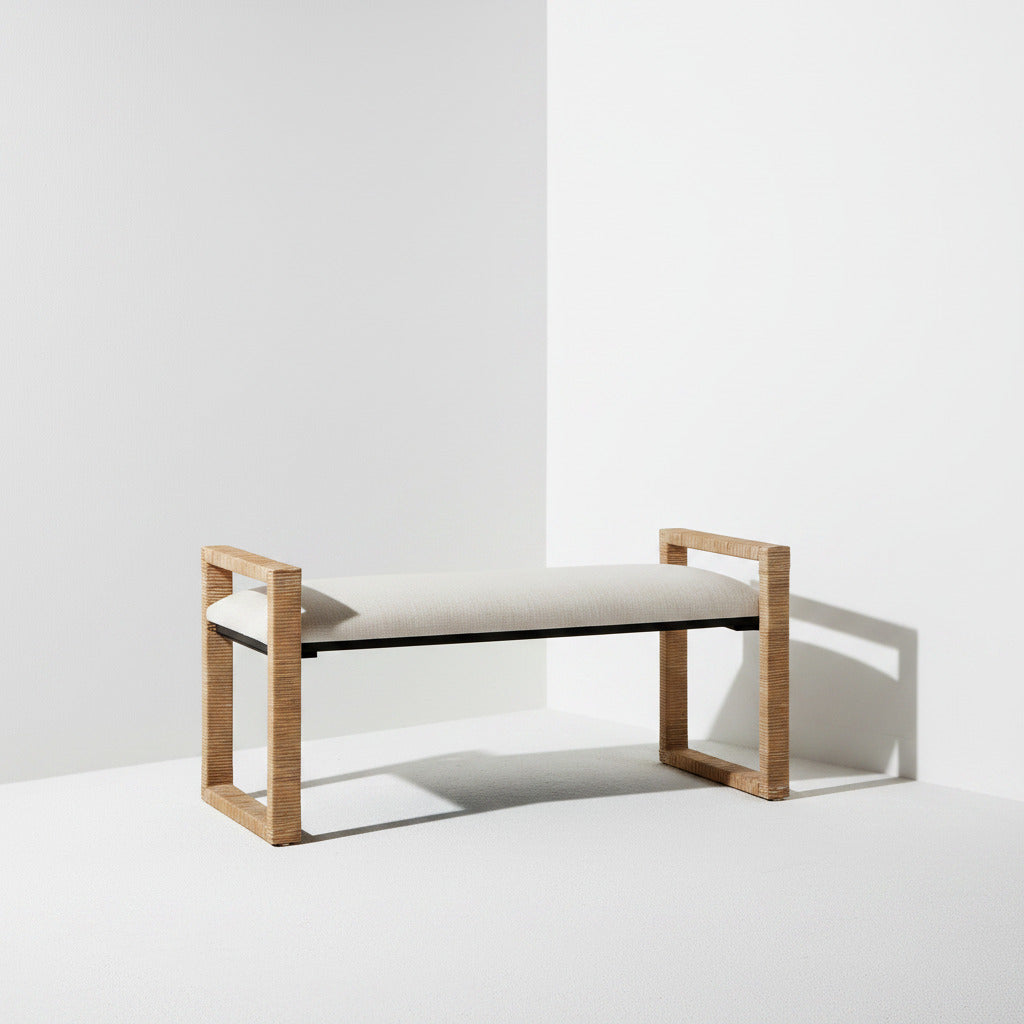 A modern bench with a light beige upholstered seat and a natural wood frame, shown in a minimalist white studio setting with a soft shadow.
