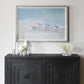 Framed wall art of coastal birds with white decorative sculptures and coral statue styled on a black rustic console.