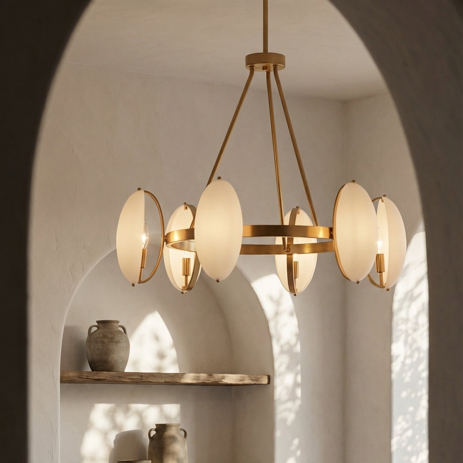 Chandelier hanging above a shelf with decorative vases in a softly lit room.