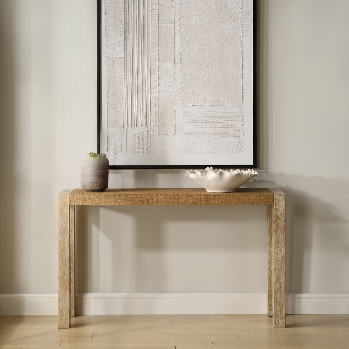 Coastal console table against a neutral living room with white decorative bowl.