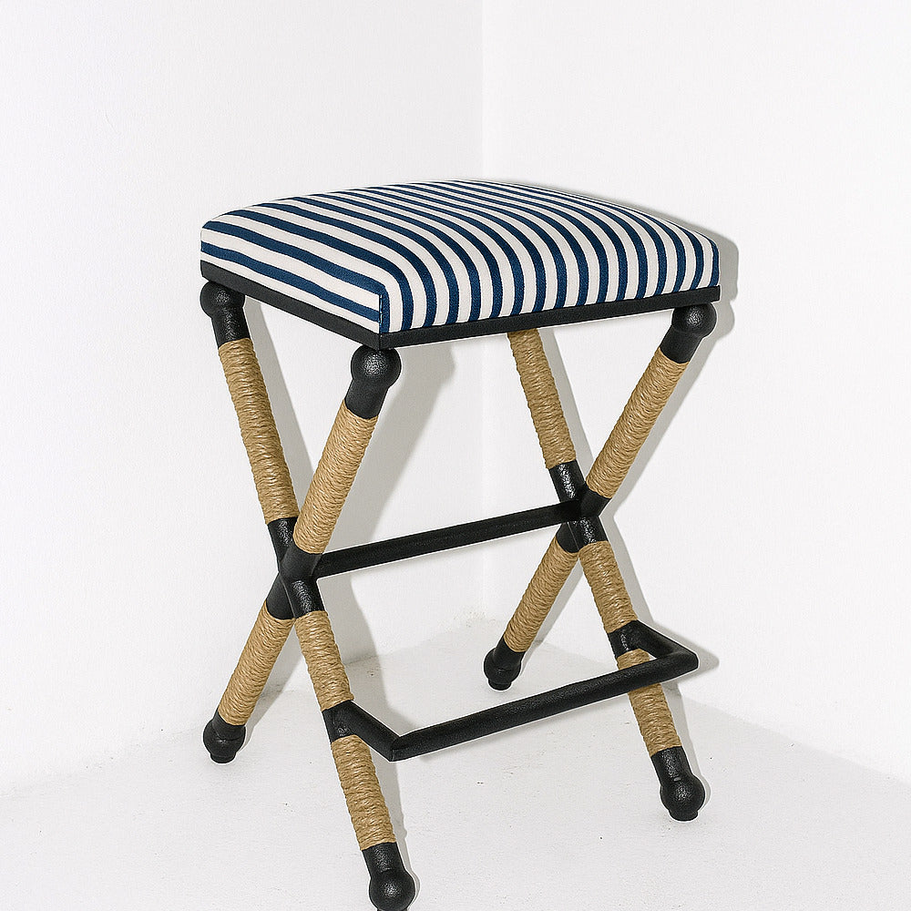 Striped stool with woven legs on a white background