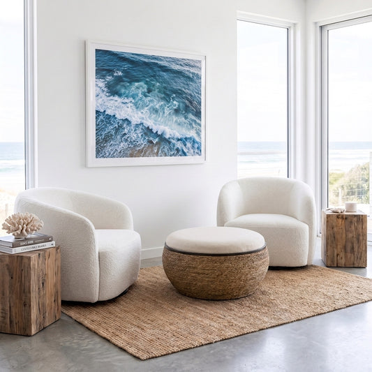 A round pouf ottoman with a textured brown woven base and a white cushioned top, set against a minimalist white background.